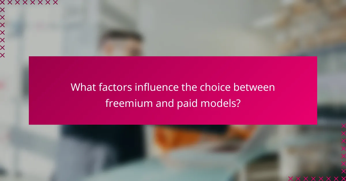 What factors influence the choice between freemium and paid models?